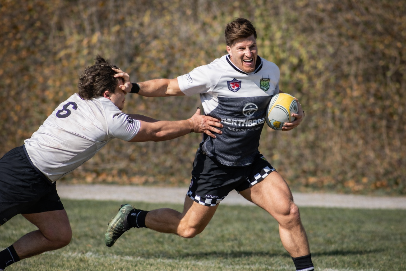 Dr. Tyler Graham playing rugby, highlighting his active lifestyle and performance-focused care