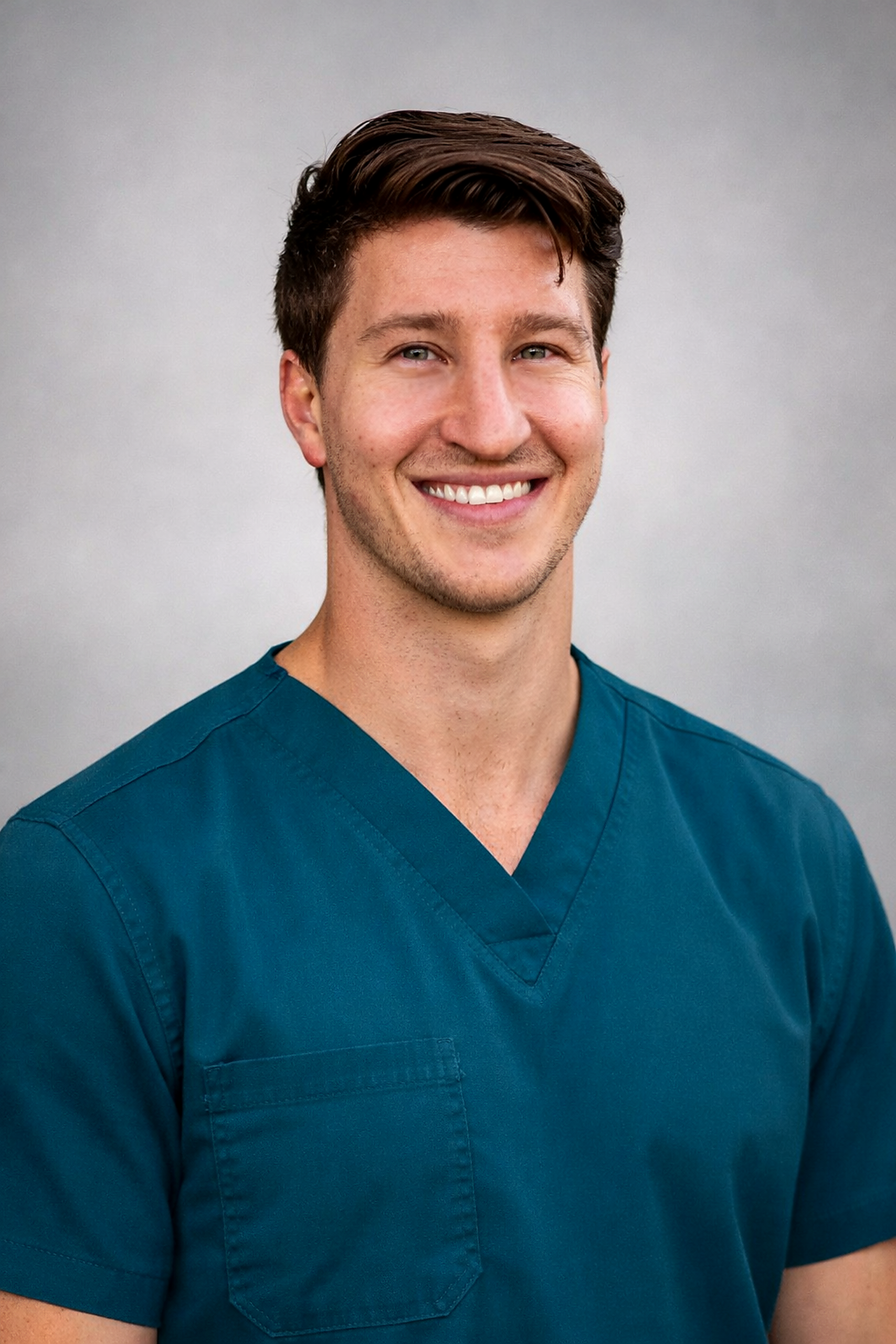 Dr. Tyler M. Graham, DC in teal scrubs at Balanced Chiropractic in Logansport, Indiana